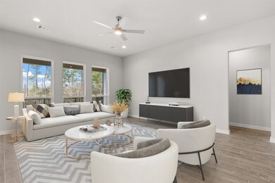 Gather the family and guests together in your lovely living room! Featuring high ceilings, recessed lighting, dark stained ceiling fan, custom paint, gorgeous floors and large windows that provide plenty of natural lighting throughout the day.
