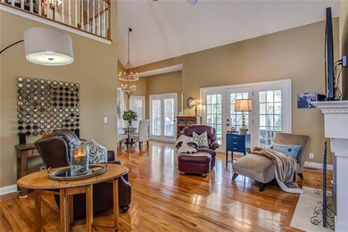 THE GREAT ROOM FEATURES A FULL WALL OF WINDOWS TO 