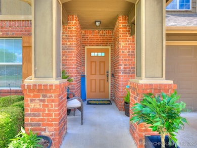 Property entrance with brick siding and a porch
