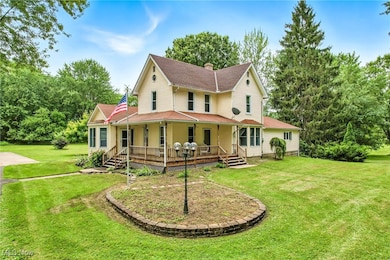 Farmhouse-style home with a porch, a front yard, and a chimney