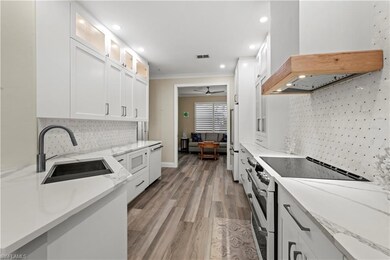 Kitchen featuring white cabinets, sink, custom ran