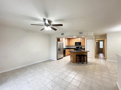 Kitchen with light tile patterned floors, black a