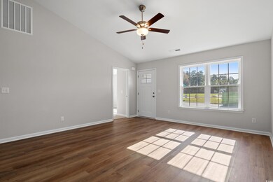 Spare room with vaulted ceiling, ceiling fan, and 