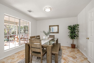 Dining area w/ large window allowing natural light to fill the space.
