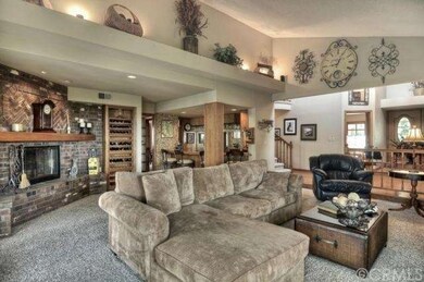 Living Room with Large Brick Fireplace and Bar wit
