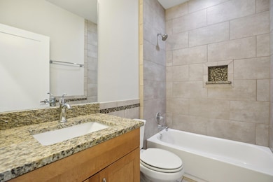 Bathroom with vanity and  shower combination