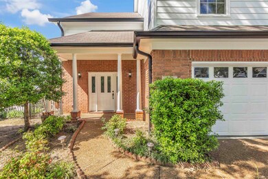 Doorway to property with brick siding, a garage, a