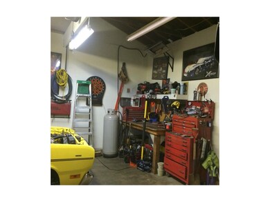 Workshop area in garage that has door leading to b