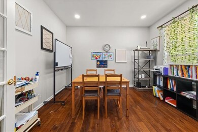 Dining room with wood finished floors and recessed lighting