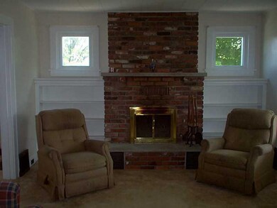Living Room. Quaint brick fireplace equipped with 
