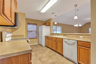 efficient kitchen includes refrigerator, brightly