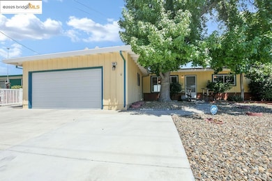 Ranch-style home with concrete driveway and an attached garage
