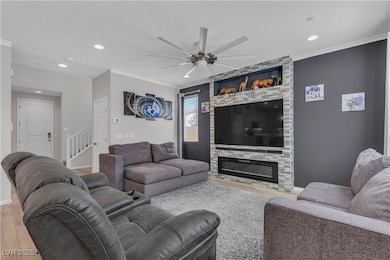 Living area featuring crown molding, wood finished