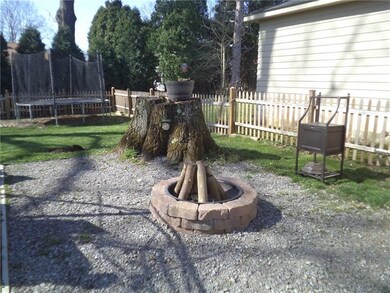 Fire pit in fenced back yard great for entertainin