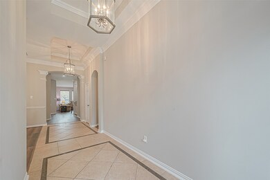 The stunning entryway features double coffered ceiling and extended crown moulding.