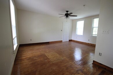 Empty room with wood finished floors, ceiling fan