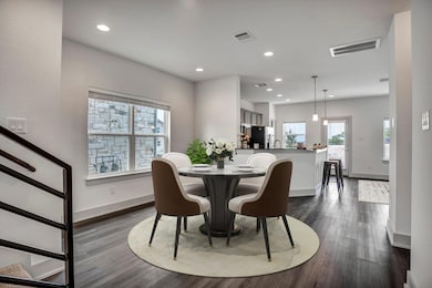 Dining space with dark wood-style floors, recesse