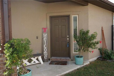 Entrance to property with stucco siding