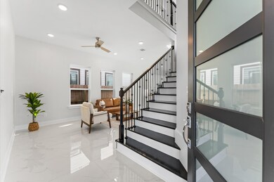Welcoming entry with sleek tile flooring and conte