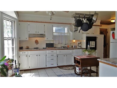 The kitchen features tile flooring, marble counter