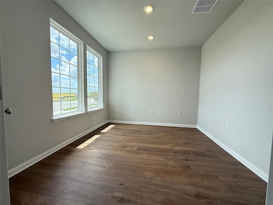 Empty room with dark wood-type flooring and reces