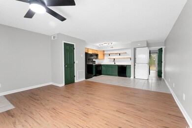Unfurnished living room featuring light tile patte