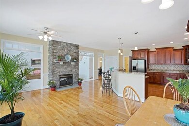 Large kitchen with stone fireplace that opens to kitchen and great room
