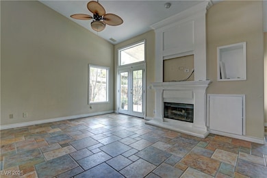 Unfurnished living room featuring high vaulted cei