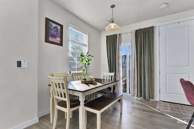 Dining space featuring wood finished floors and baseboards