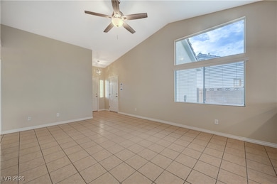 Spare room featuring high vaulted ceiling, ceiling