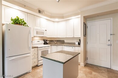 Kitchen featuring a center island, sink, light sto
