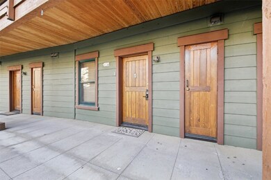 Entrance to property featuring a patio and storage locker to the right.