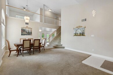 Dining room featuring carpet floors, a towering c
