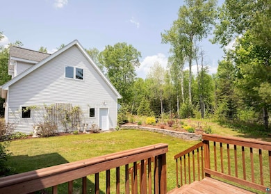 Wooden terrace featuring a yard