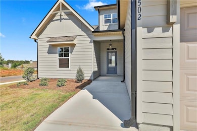 Doorway to property featuring a lawn