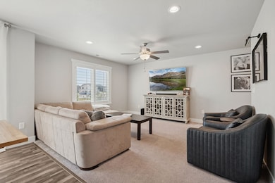 Living area featuring recessed lighting and ceiling fan