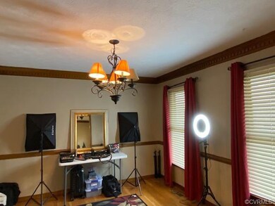 Formal dining room featuring wood floors, dentil c