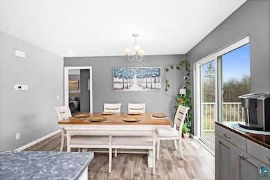 Dining room featuring baseboards, an inviting chan