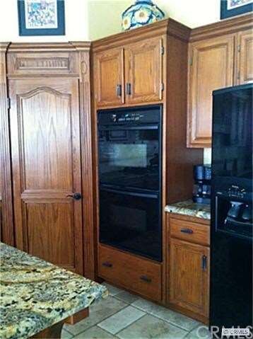 Corner walk in pantry, double ovens and custom woo