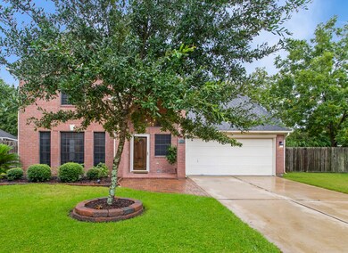 This attractive two-story home has curb appeal, covered front entryway, and a double-wide driveway.