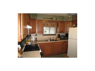 Kitchen with ceramic tile floor.