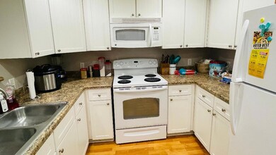 Kitchen featuring light stone counters, light wood