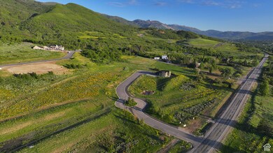 Aerial view of property and surrounding area featuring mountains
