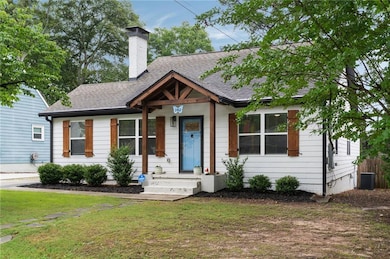 View of front of home featuring a front yard, central air condition unit, a shingled roof, and a chimney