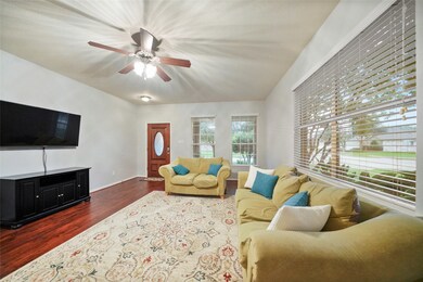 Spacious LIVING ROOM with laminate flooring and LOTS of natural light.
