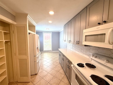 Spacious kitchen with appliances, ample cabinetry, and a cozy dining nook for entertaining or breakfast.