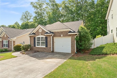 Single story home featuring brick siding, an attac