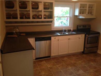 The kitchen has new flooring, new paint, and brand