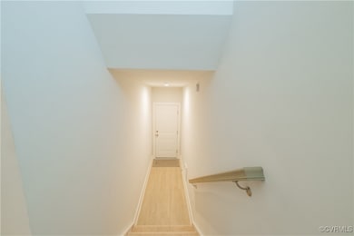 Stairway with baseboards and wood finished floors