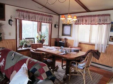 Dining Room. Dining area w/ wainscoating and bay window.